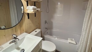 A bathroom with a sink, toilet, and shower. - Drifters Motel and Restaurant (Terrace Bay)