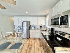Fridge, microwave, oven, stovetop - Steps to the Sand: Bright, Spacious Condo on South-End Beach Block (Ocean City)