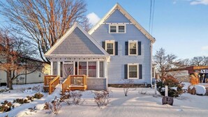 A two-story house with a front porch and a garage.