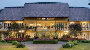 A two-story building with a paved walkway leading to the entrance, surrounded by well-maintained landscaping. - Binh An Village Dalat Resort (Da Lat)