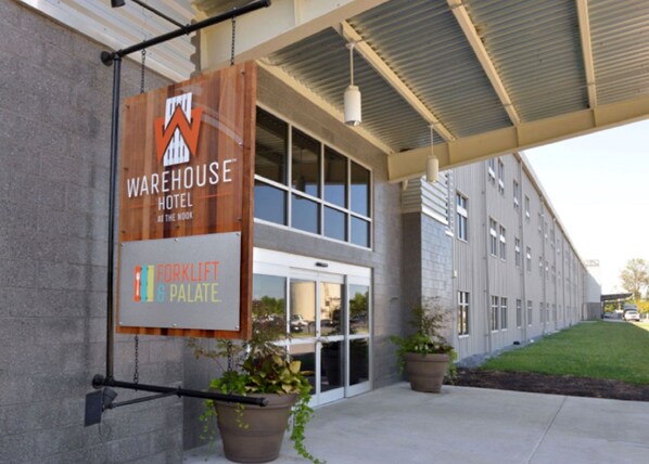 Un edificio con un letrero que dice 'Warehouse Hotel' y 'Forklift Palace'.