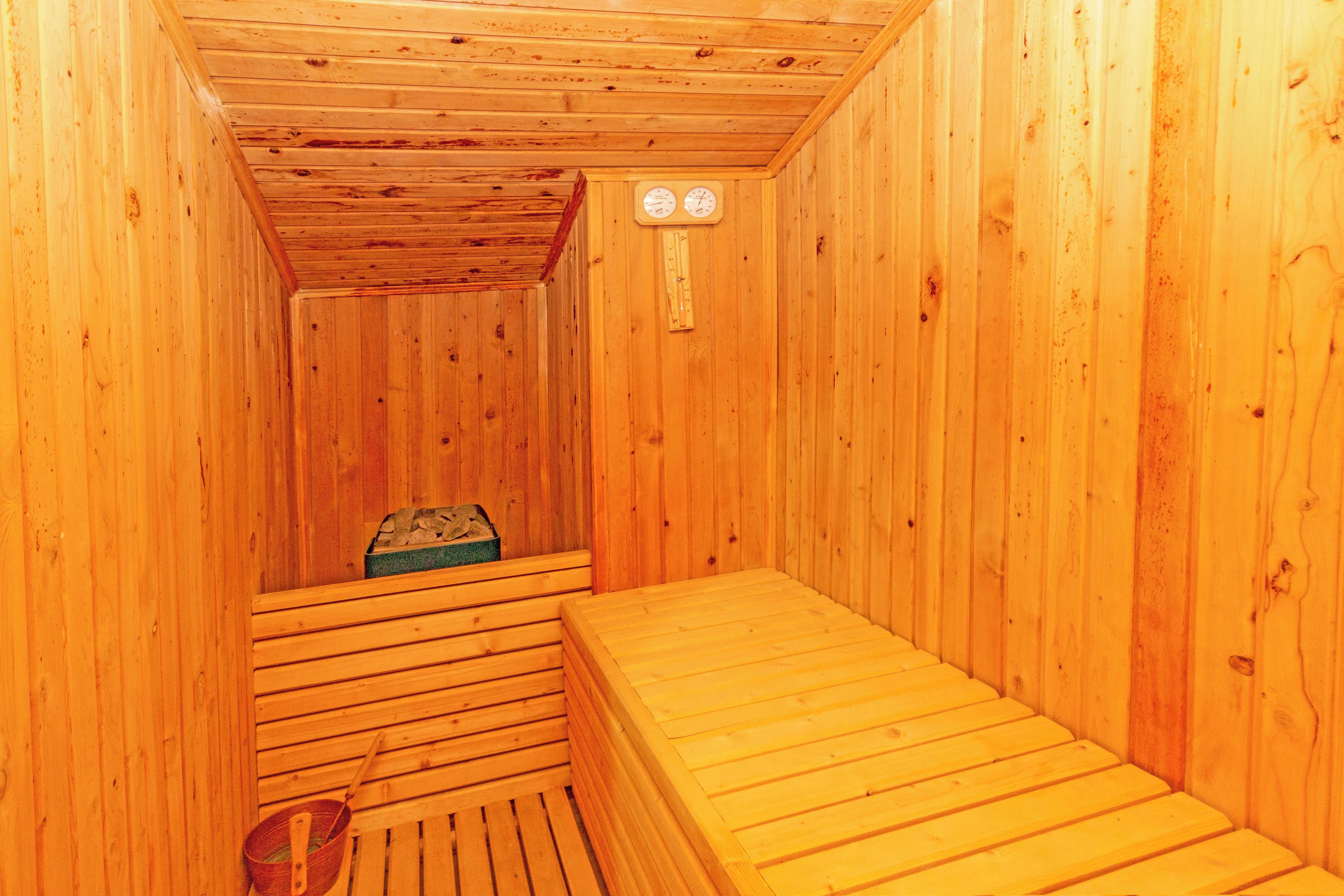 A sauna with wooden walls and benches.