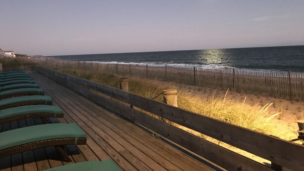A wooden deck with green cushioned chairs overlooking the ocean. - Ocean Surf Resort (Montauk)