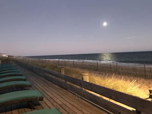 A wooden deck with green cushioned chairs overlooking the ocean. - Ocean Surf Resort (Montauk)