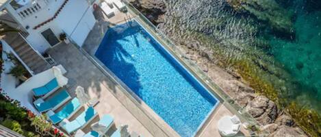 Seasonal outdoor pool, open 9:00 AM to 10:00 PM, pool umbrellas