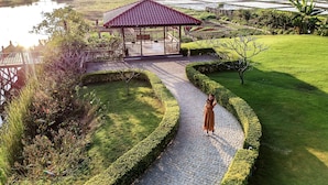 A gazebo with a tiled roof, surrounded by a landscaped garden with a paved pathway. - Sanctum Inle Resort (Nyaungshwe)