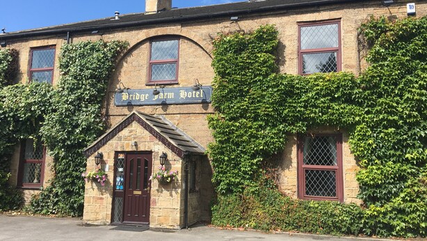 A traditional brick building with a sign reading "Bridge Farm Hotel." - Bridge Farm Hotel (Leeds)