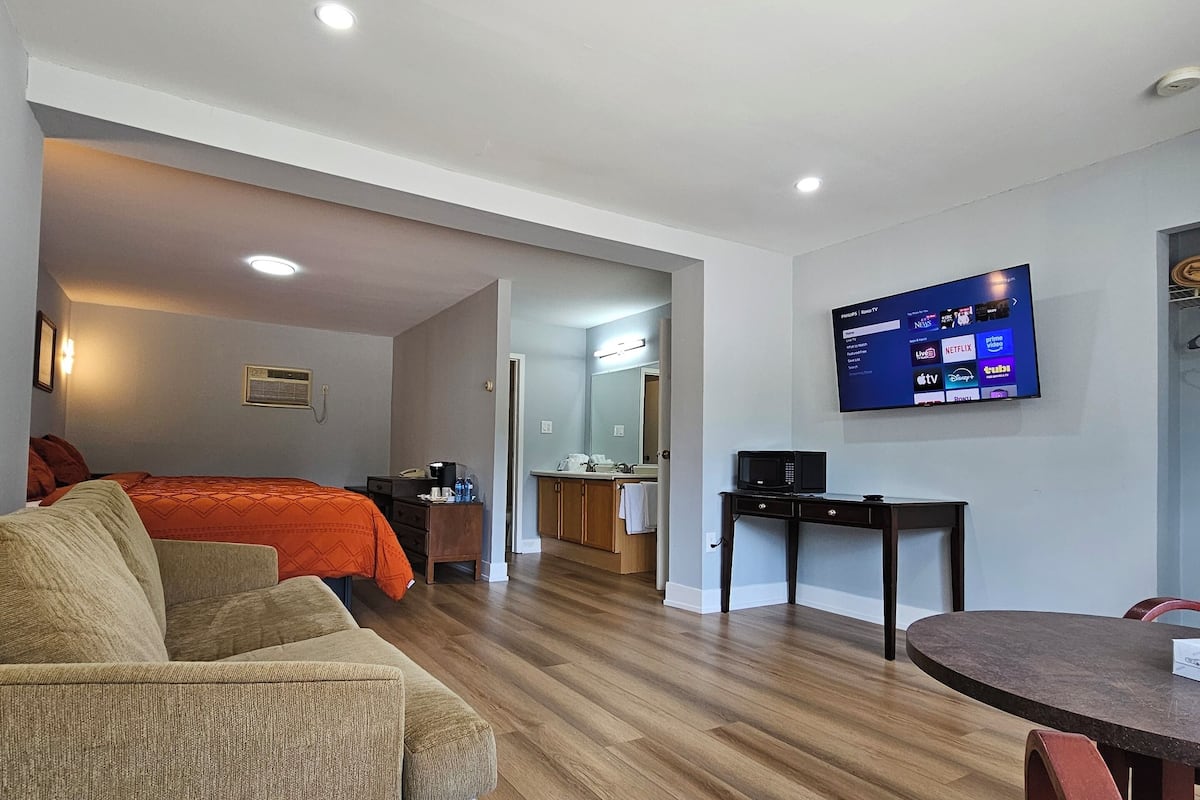 Premium bedding, desk, laptop workspace, blackout drapes