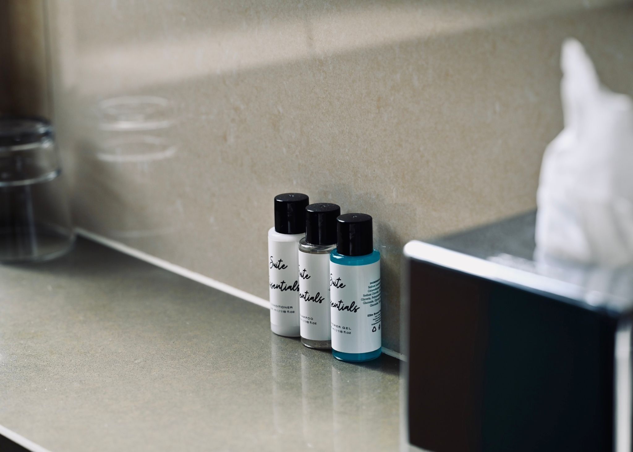 Three bottles of hair care products on a countertop.