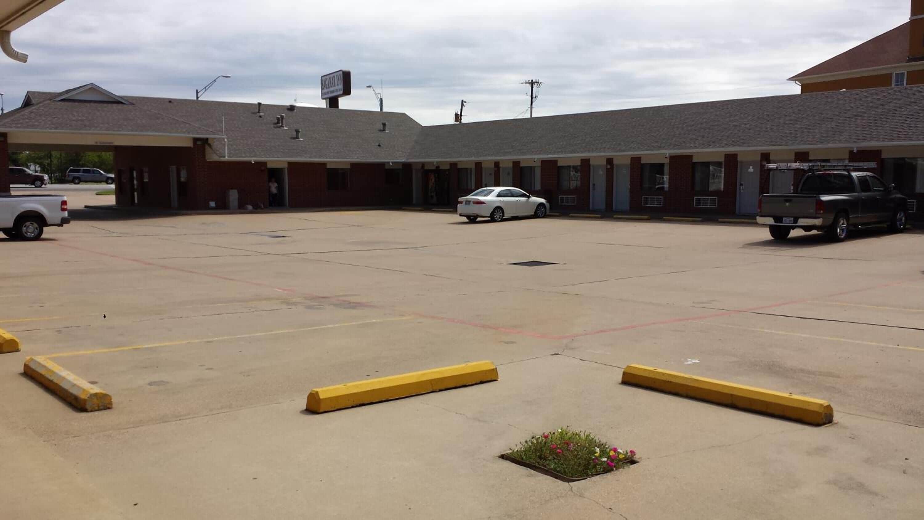 A parking lot with a building in the background.