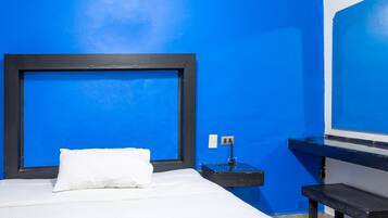 Desk, laptop workspace, bed sheets