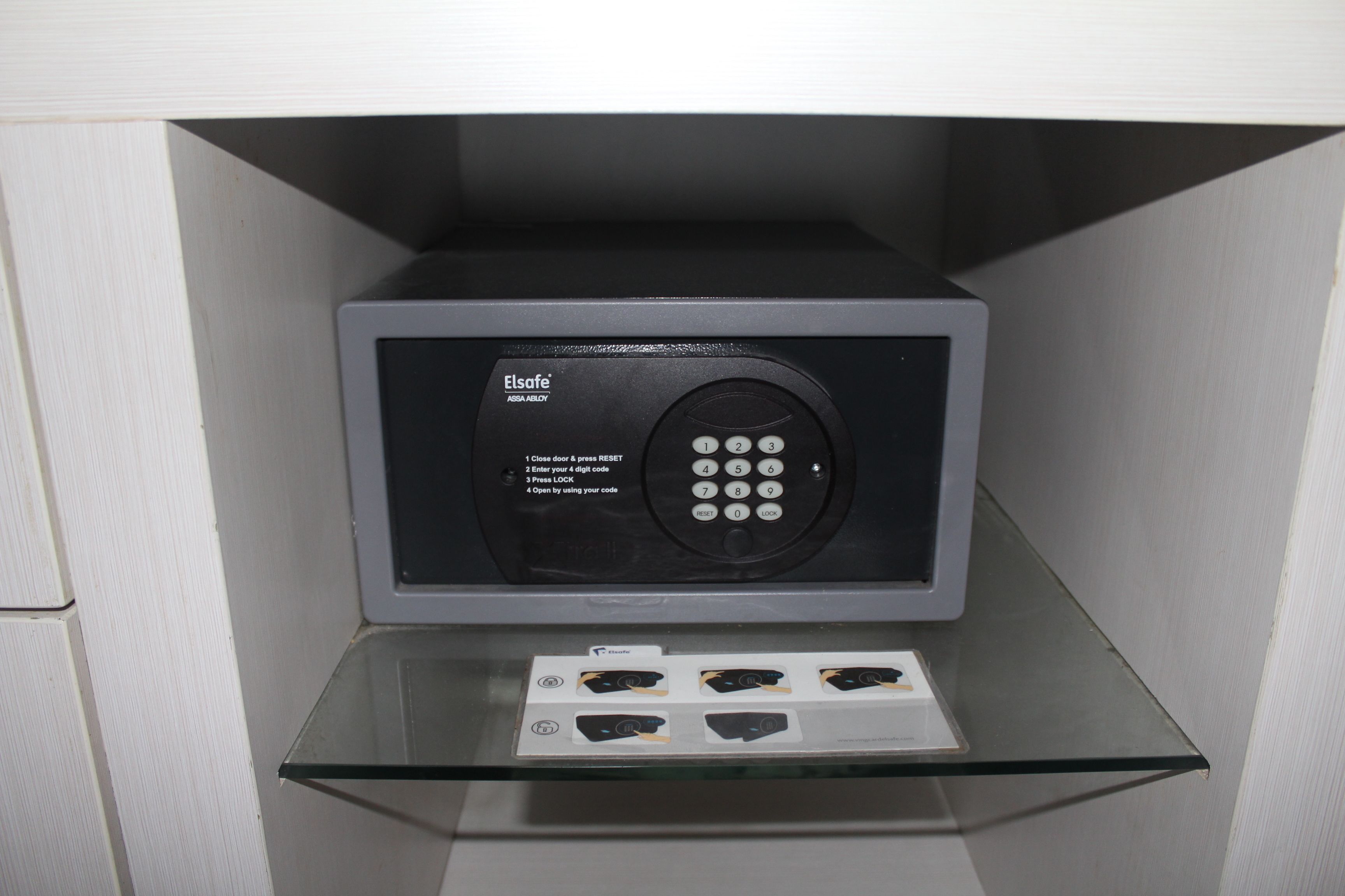 A security keypad with instructions and a glass display case with items.