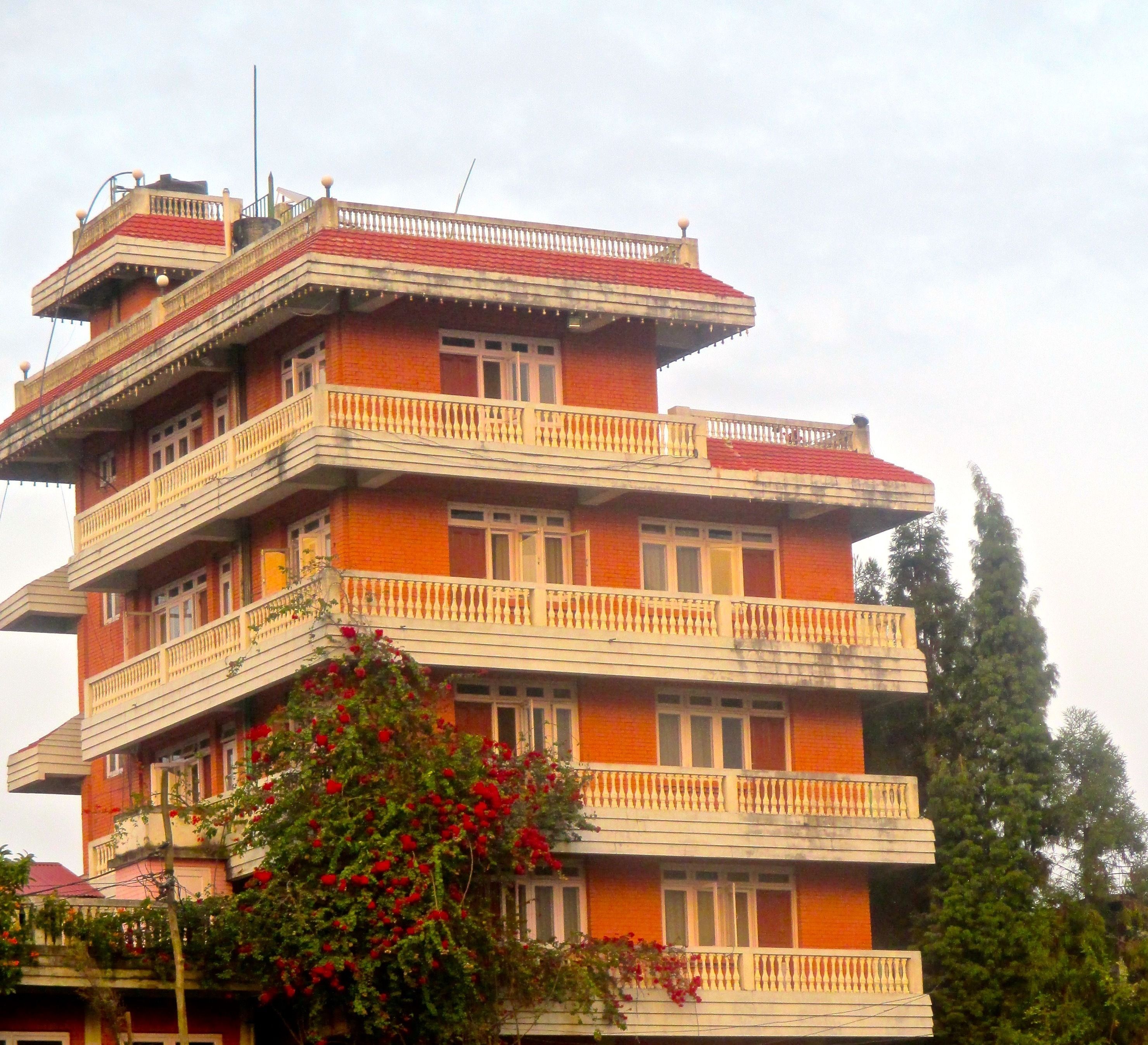 A multi-story building with balconies and windows.