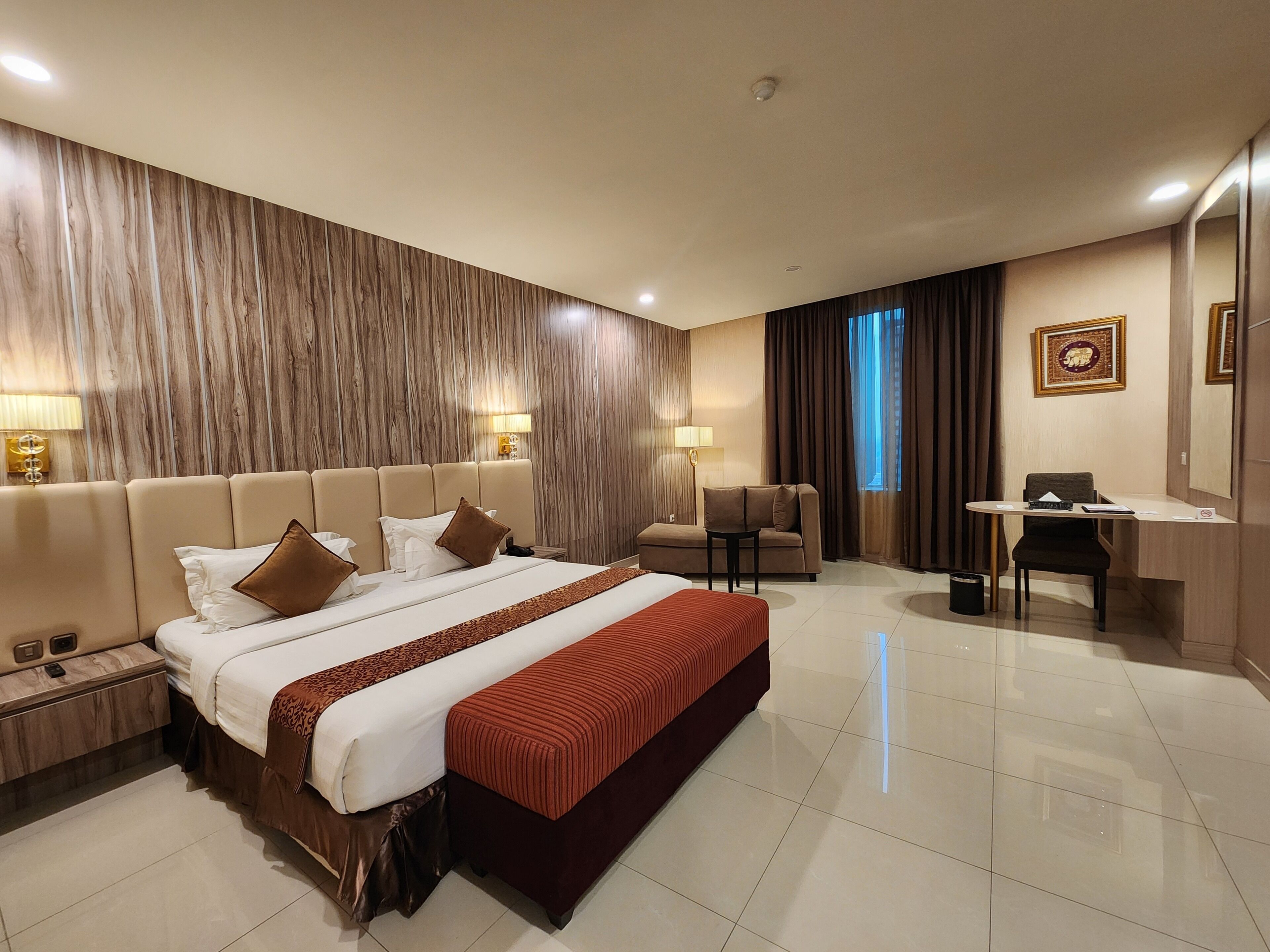 Executive Suite | Minibar, in-room safe, individually decorated, desk