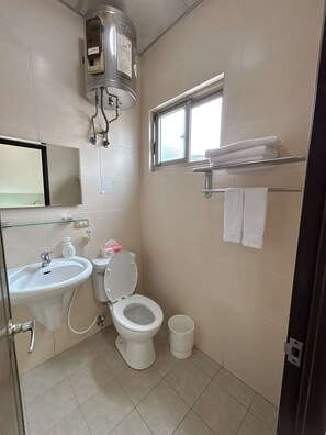 A bathroom with a toilet, sink, and a window. - Taipei Happy Home (Taipei)