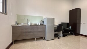 A compact kitchen with a sink, a refrigerator, and a small countertop. - Taipei Happy Home (Taipei)