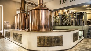 A stainless steel brewing apparatus in a commercial kitchen setting.