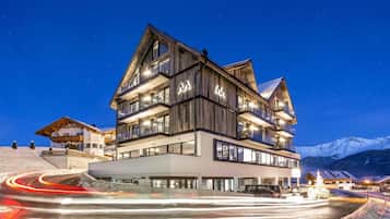 A multi-story hotel with a modern design, featuring balconies and large windows.