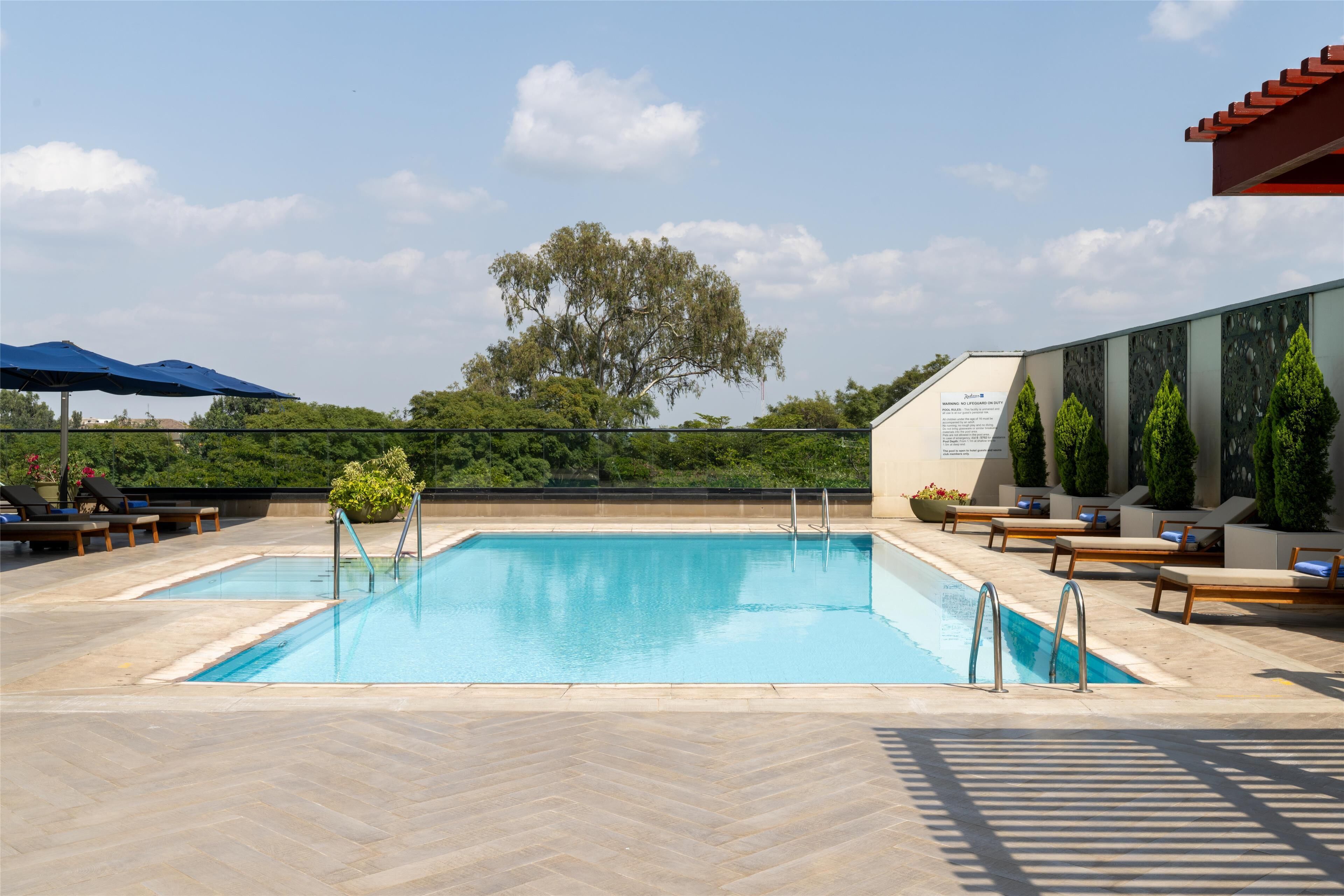 outdoor pool, pool umbrellas, pool loungers