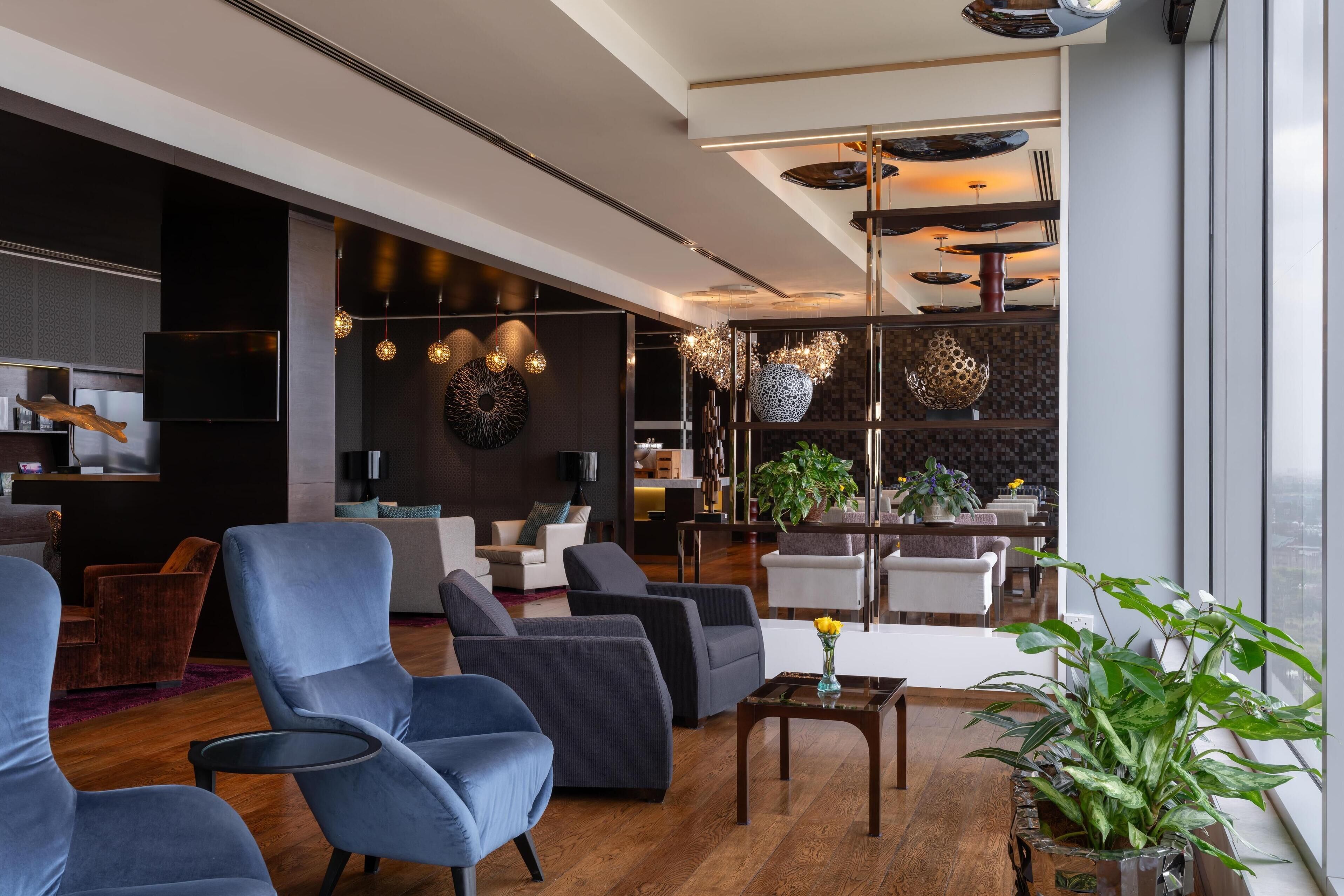 A modern living room with sofas, a coffee table, and a large window.