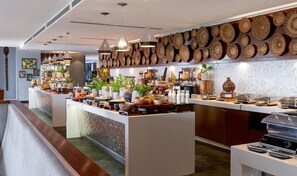 A modern breakfast bar with a variety of food items and decorative elements. - Radisson Blu Hotel Nairobi Upper Hill (Nairobi)