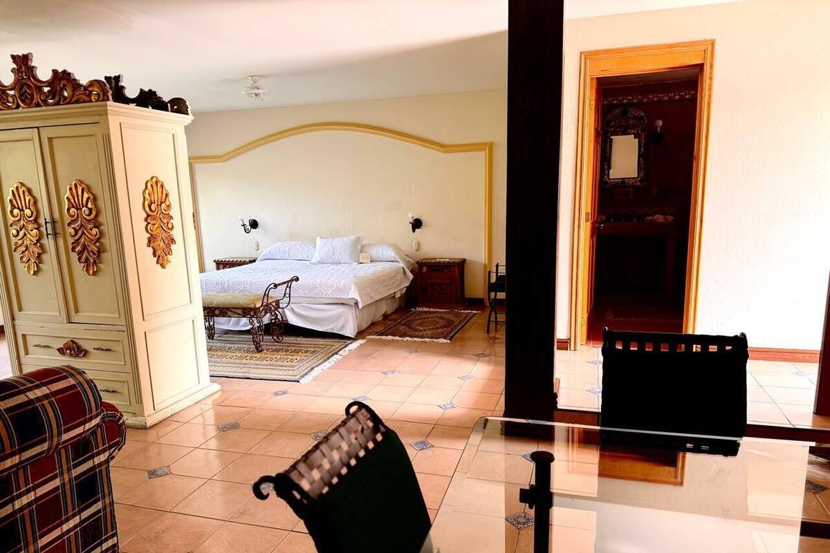 Ein Hotelzimmer mit einem Bett, einem Schrank, einem Sessel und einem Tisch.