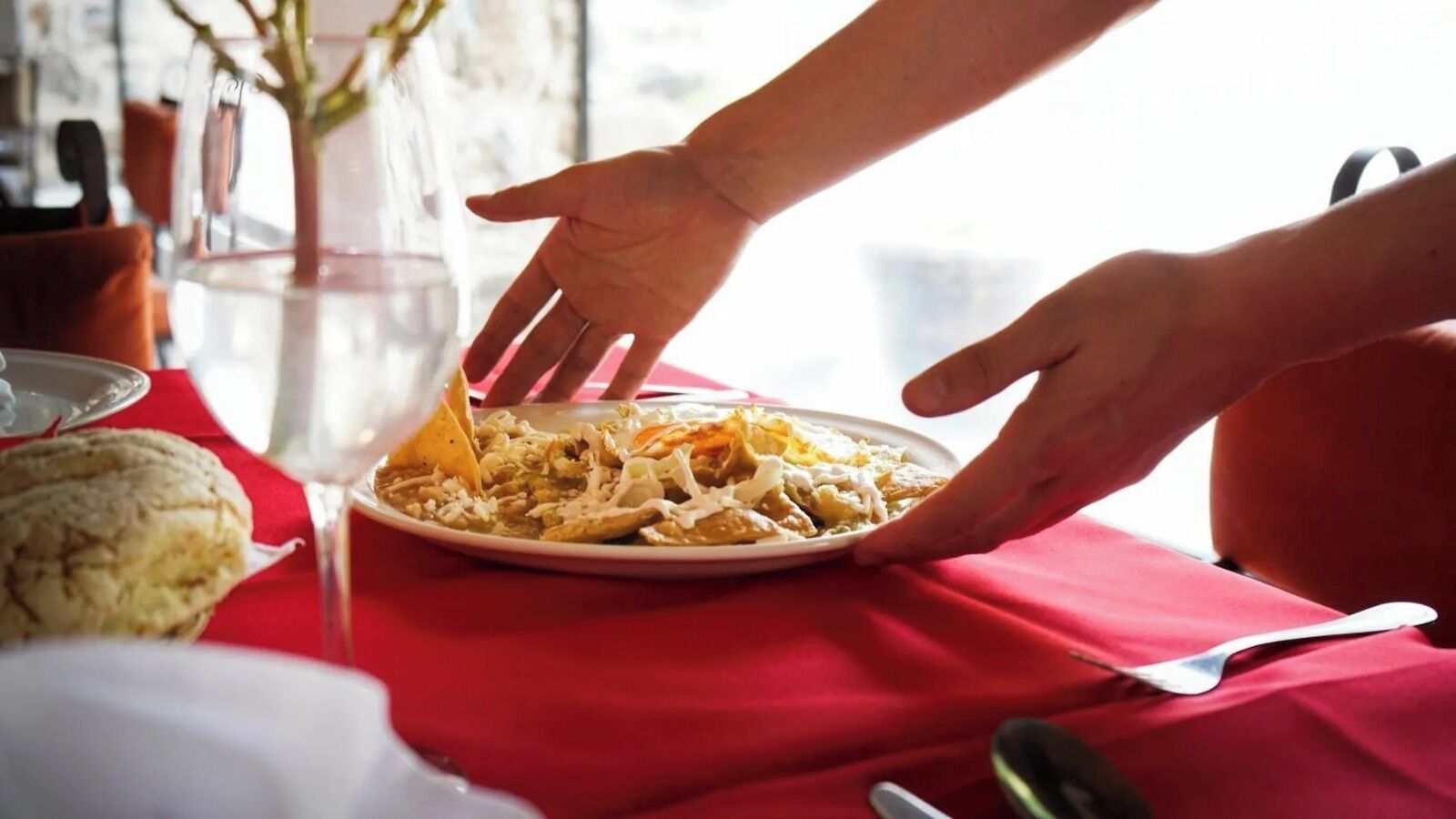 A plate of food on a table with a red tablecloth.