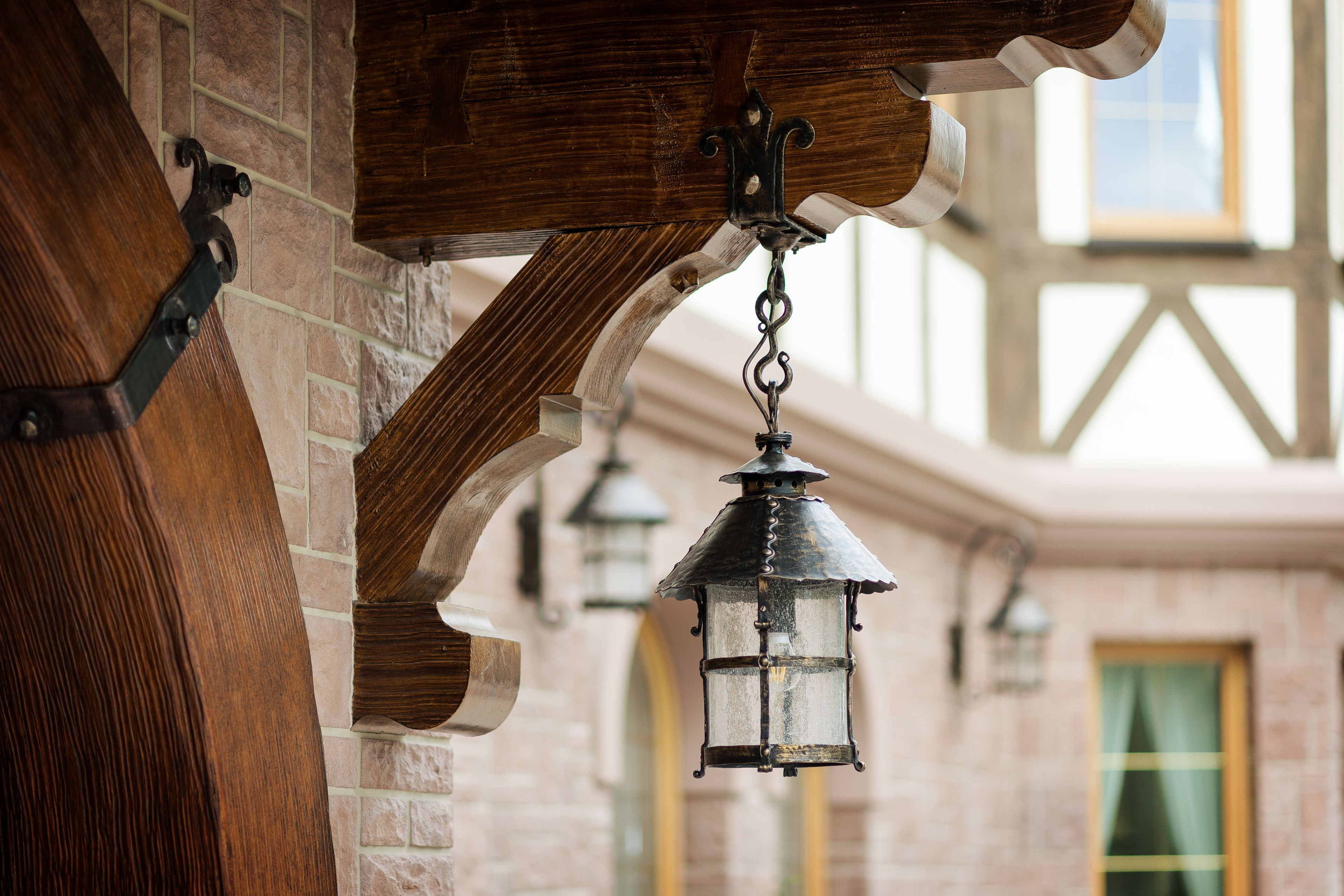A wooden beam structure with hanging lanterns.