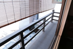 A balcony with a metal railing and a view of the street below. - Kyomachiya-Oyado Hana (Kyoto)