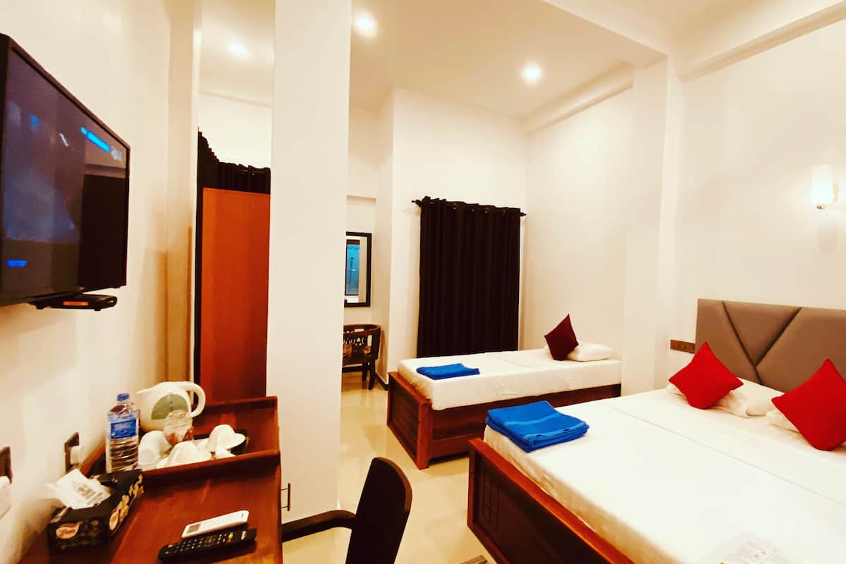 Deluxe Triple Room, Partial Sea View | Premium bedding, pillow-top beds, minibar, in-room safe