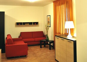 Deluxe Apartment, Terrace, Mountain View | Living area | 24-inch flat-screen TV with satellite channels, TV - Residence Cimone (Riolunato)