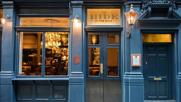 A building facade with a sign reading "The Hide at the Bull". - The Bull and The Hide (London)