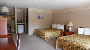 A hotel room with two beds, a desk, and a chair. - Valley Inn (Hamilton)