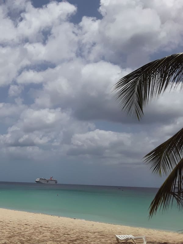 On the beach, white sand, sun-loungers, beach towels
