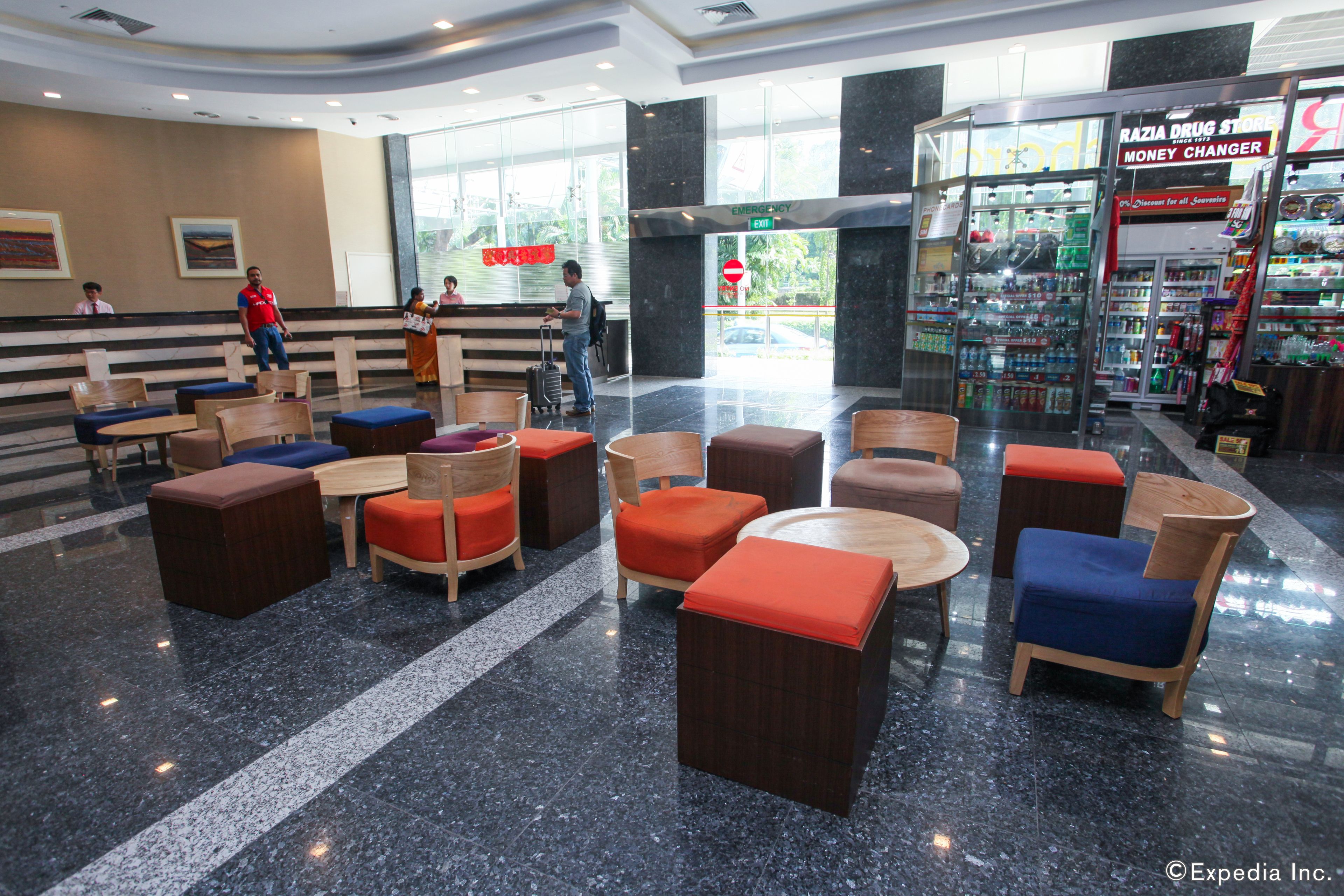 A lobby with seating areas, a reception desk, and a pharmacy.