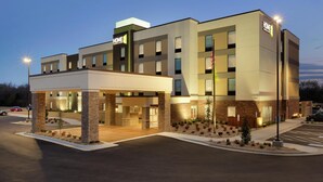 A multi-story hotel with a flat facade, a covered entrance, and a parking lot. - Home2 Suites by Hilton Fort Smith AR (Fort Smith)