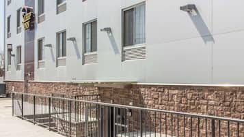 A Sleep Inn building with a stone base and metal railing.