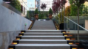 A staircase with a modern design, leading up to a building entrance. - Lux Lisboa Park (Lisbon)