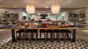 A buffet setup with various food items and a red toaster. - Lux Lisboa Park (Lisbon)