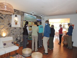 Guests can gather around the map on the stone wall in this cozy space.