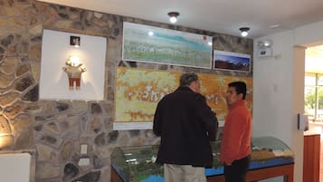 A stone wall with a map and a glass display case.