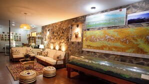 A cozy lounge area with sofas, a coffee table, and a decorative fish tank.