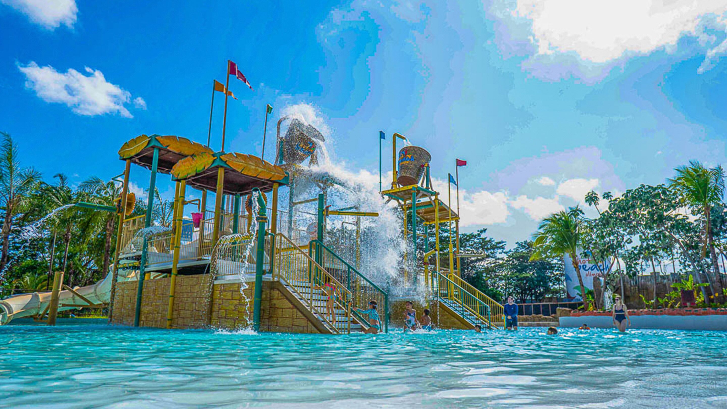 A water park with multiple water features, including a water slide and a wave machine.