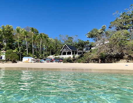 On the beach, sun-loungers, beach umbrellas, beach towels. Mar Y Oro