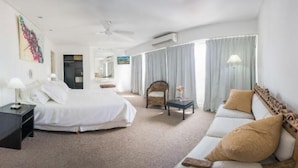 A hotel room with a bed, a sofa, a chair, a small table, and a desk. - Hotel Corbel (Mar del Plata)