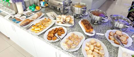 A buffet with various food items and beverages.