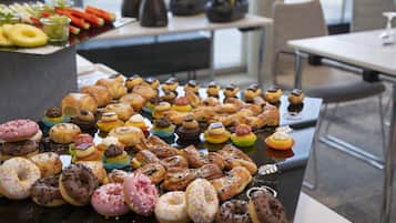 A buffet table with a variety of pastries and desserts.