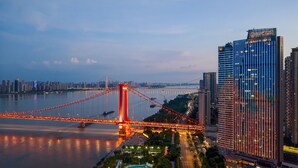 A modern hotel with a view of a bridge and river.