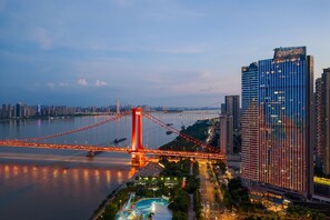 A modern hotel with a view of a bridge and river.