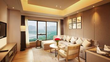 A modern living room with a sofa, a coffee table, a TV, and a large window overlooking a cityscape.